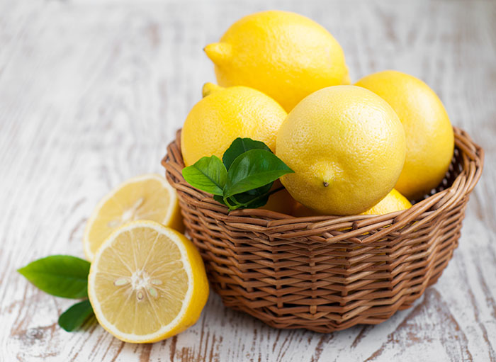 Basket with Lemons on a wooden background