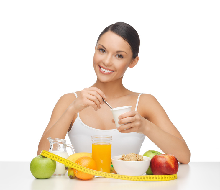 young woman with healthy breakfast and measuring tape
