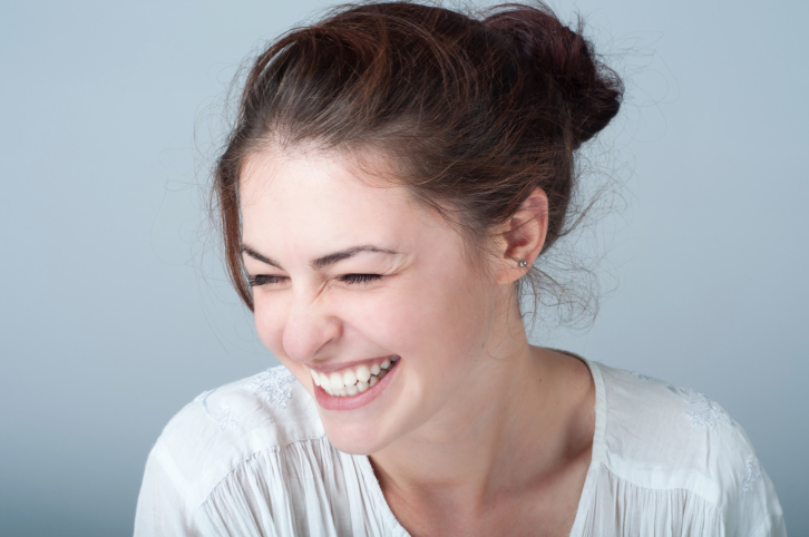 young woman portrait with a toothy smile
