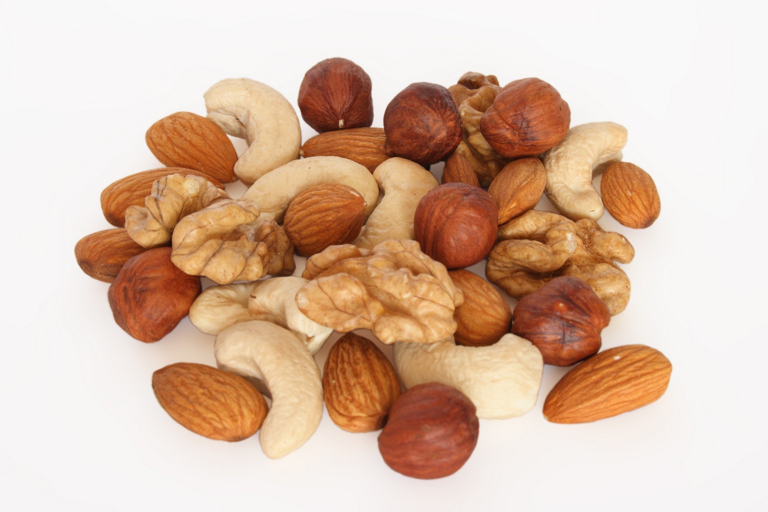 Pile of assorted nuts isolated over white background