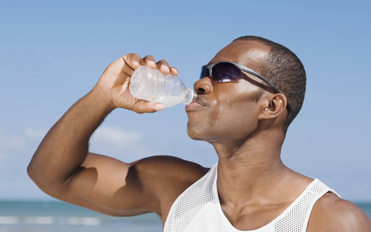 African man drinking water bottle